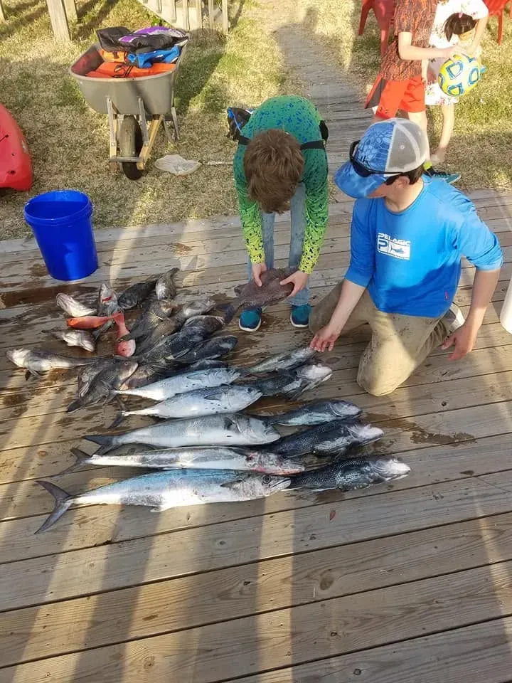 Family with their catch on a dock