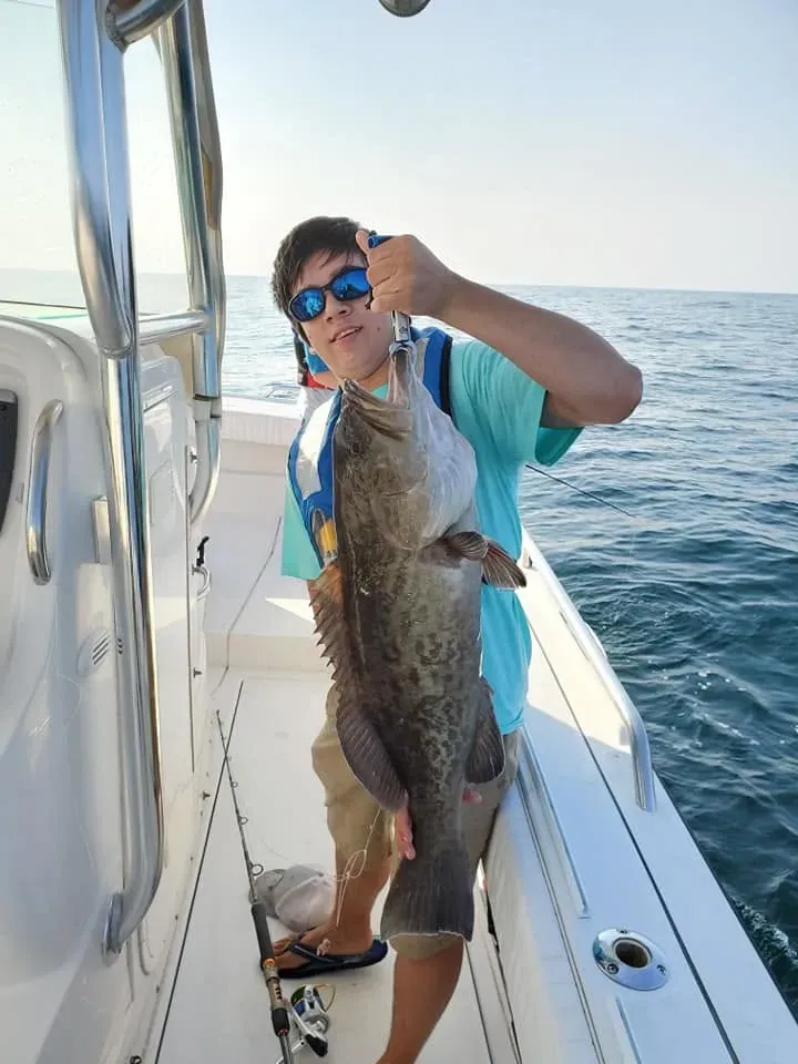 Angler holding a red snapper offshore