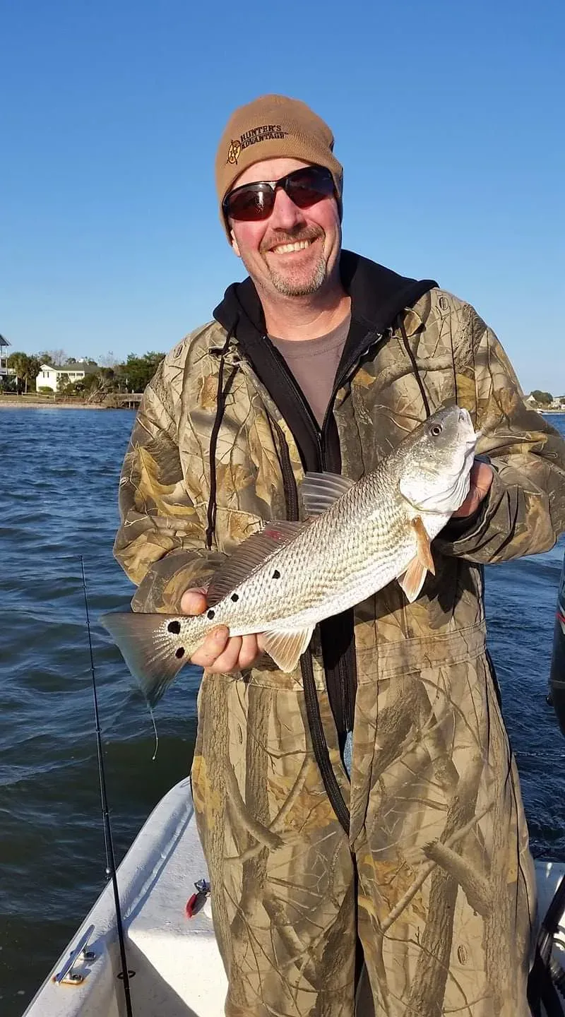 Angler holding a speckled trout