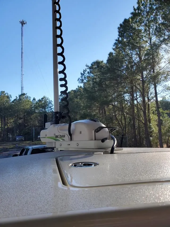 GPS trolling motor mounted on a bow under the pines