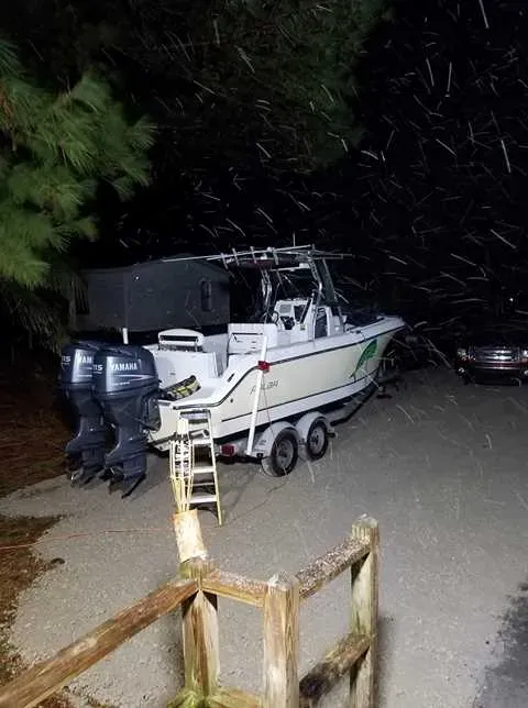 T-top boat with twin Yamahas on its trailer